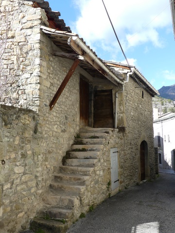 Escalier extérieur, entrepôt agricole au bourg.