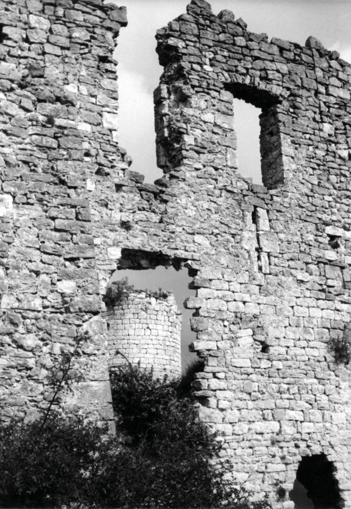 [Château de Bargème, mur occidental du corps de logis, vestiges de fenêtres et d'une archère, tour sud-est à l'arrière-plan, vers 1962].