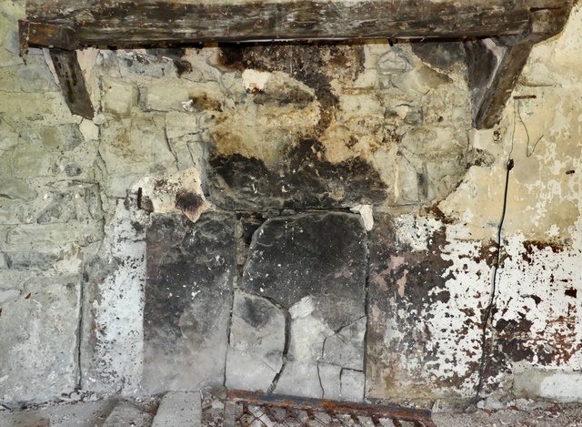 Bâtiment principal. Rez-de-chaussée surélevé, cuisine. Mur nord, cheminée avec pierres foyères en grès.