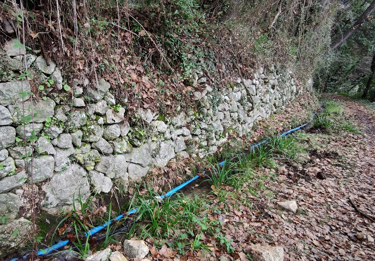 Quartier de la Béou. Canal d'irrigation en pleine terre le long du chemin muletier au nord du moulin dit de Cairanq.  