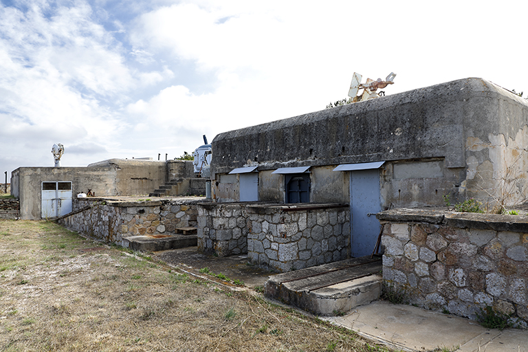 Aile droite de la batterie, côté chemin de ronde intérieur, façade et portes d'un magasin de combat, murs et piles d'appui des passerelles du chemin de ronde surélevé.