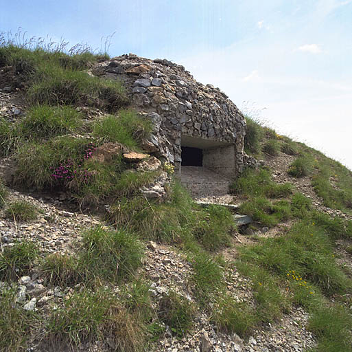 Extérieur de l'emplacement de tir sous coupole de béton, camouflage en pierraille.