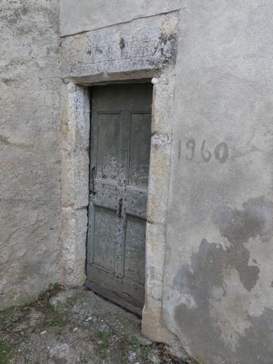 Porte de logis avec encadrement chanfreiné à accolade, et linteau portant la date gravée 1684 et les initiales P et R ; menuiserie à panneaux moulurés. Ferme au hameau de la Combe (Ribiers).