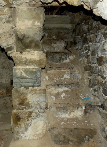 Partie ouest, étage de soubassement. Escalier remployant divers blocs à bossage.