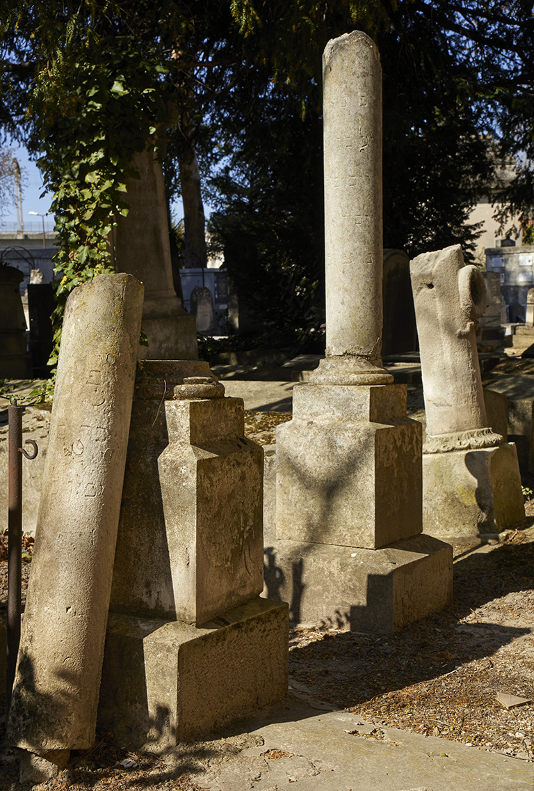 Vue des stèles à colonne brisée (stèles d'enfant) à proximité du mur est du cimetière.