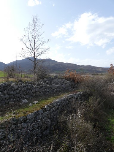 Chemin sur mur de soutènement, bordé par un pierrier bâti. Quartier de Barbelle.