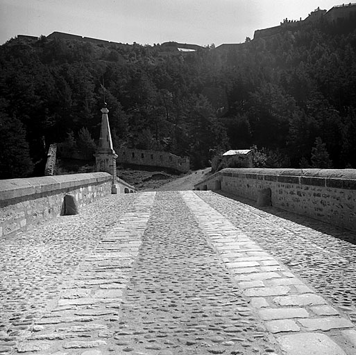 Vue prise dans l'axe de la chaussée depuis la rive ouest. A l'arrière et au-dessus, la gorge du fort des Têtes.